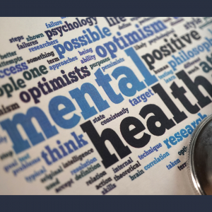 A word cloud with the words mental health, depression, wellness, and others highlighted. The text is in shades of blue and black on a white background.