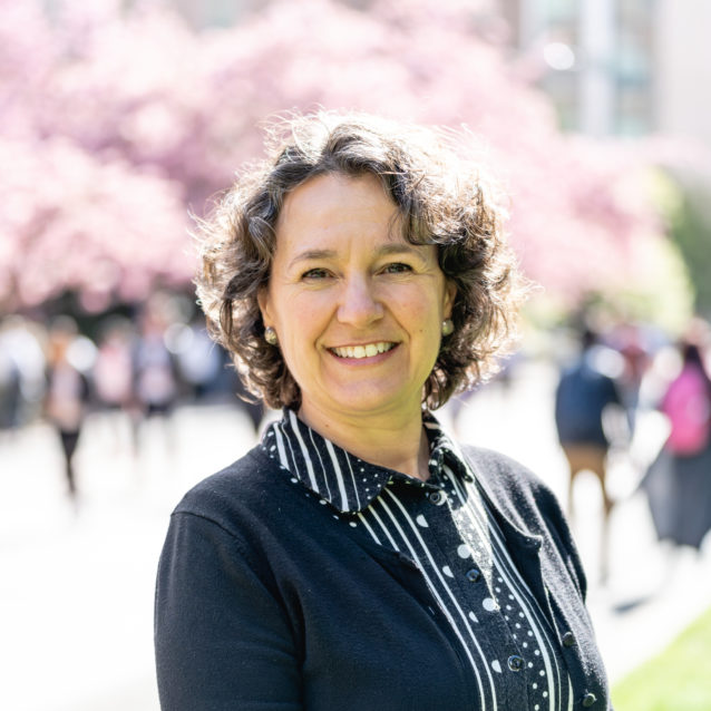 A smiling photo of Penny Watridge Rn , Health Health. Penny has short black hair and is wearing a black top.